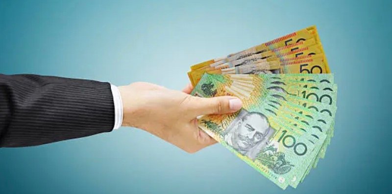 Man holding Australian dollars